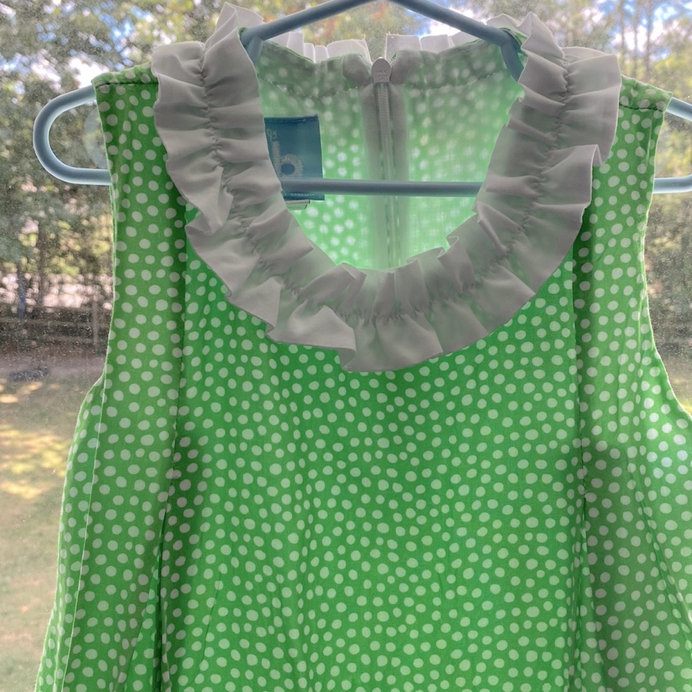 Bella bliss girls green dress with white polka dots.